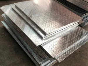 Compound steel grating base panel with welded checker plate
