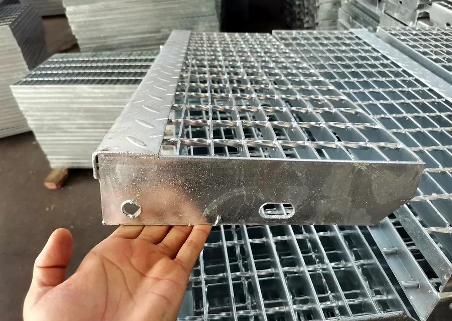 Galvanized steel grating stair tread detail with side plate and fixing holes