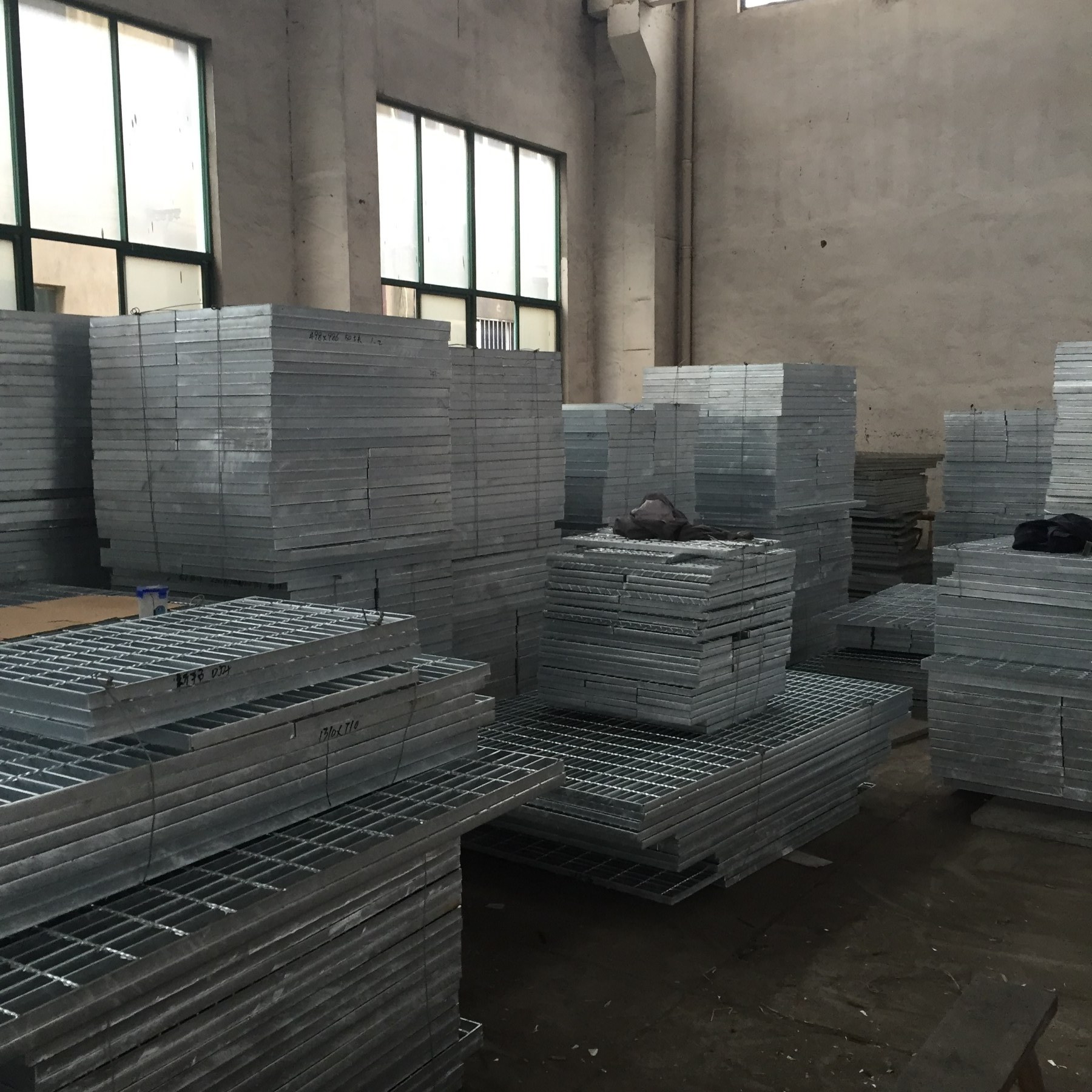 Upright industrial platform steel grating panels stacked for RFQ review