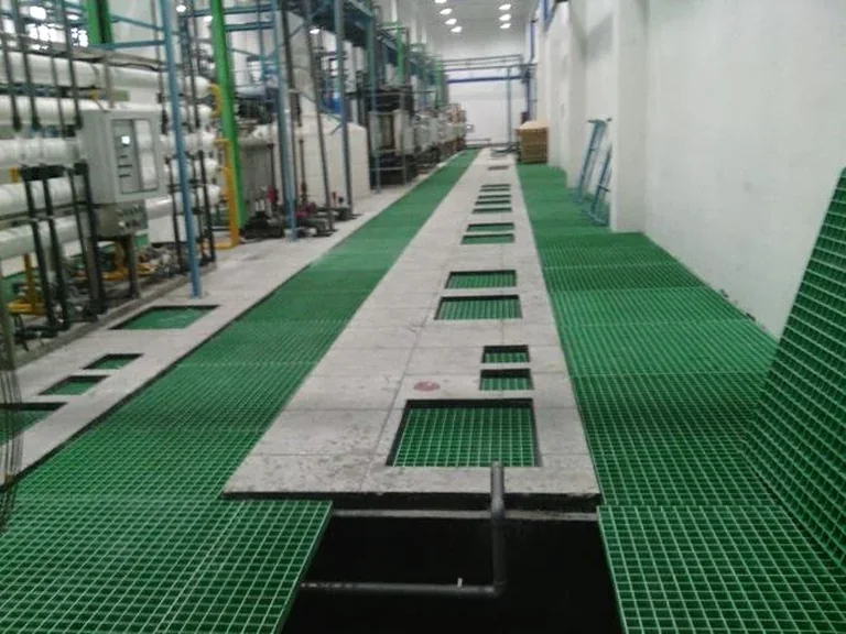 Green molded FRP grating installed in wet industrial floor area
